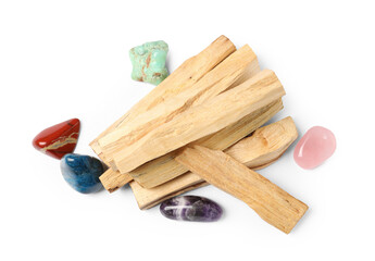 Palo santo sticks and gemstones isolated on white, top view