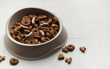 Brown slow feeder bowl with dog food pieces