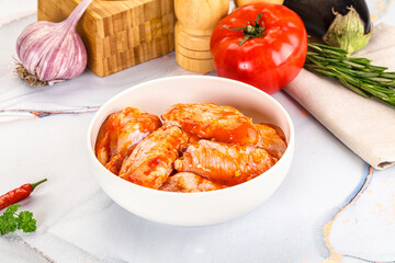 Raw marinated uncooked chicken wings