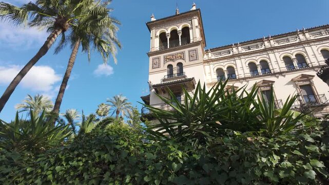 Seville, Spain, view of the lush greenery and iconic architecture of Hotel Alfonso XIII