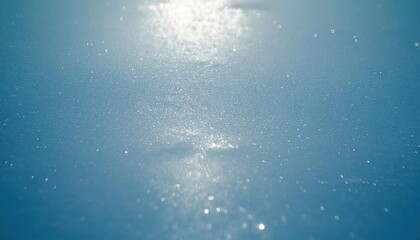 soft sunlight reflection on the textured frozen lake surface with shimmering ice crystals, creating a serene winter abstract scene

