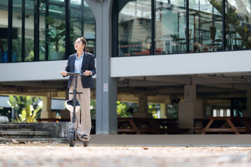 Young businesswoman riding an electric scooter in a modern urban environment, showcasing...