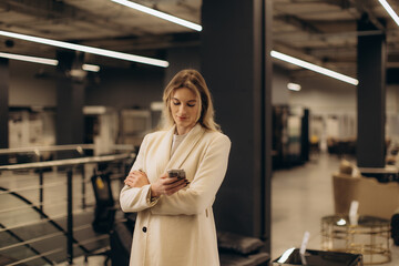 Professional Woman Using Smartphone in Modern Indoor Office Environment
