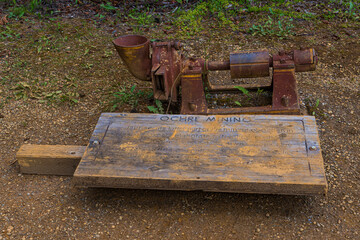 A rusted ochre mining device sits on the ground, showcasing the historical mining methods for...