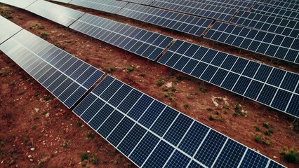 Lots of solar panels on top of a hill, a bird's-eye view from a drone