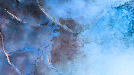 Vibrant ice texture illuminated by sunlight, showcasing shimmering patterns and frosty crystals in...