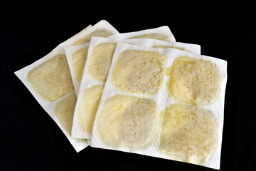 Medical warming plasters for the treatment of colds lie on a white background.