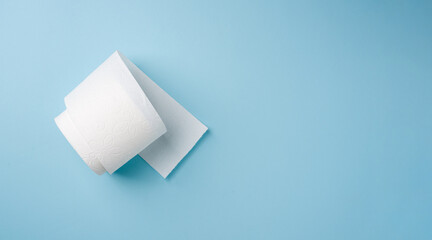 Top view of toilet paper roll on blue background