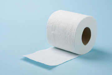 Top view of toilet paper roll on blue background