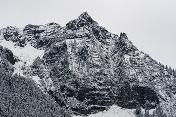 This striking image features majestic snow-covered mountain peaks, encapsulating the grandeur of...