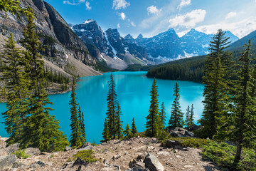 A stunning turquoise lake surrounded by towering mountains reflects the beauty of nature, inviting adventure and exploration into this picturesque landscape.