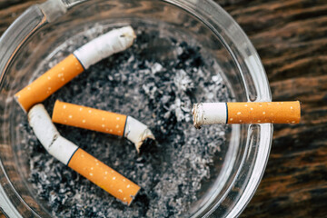 cigarette in ashtray on wooden background