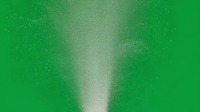 Water jet powerfully spraying upward, creating dynamic liquid motion with vibrant energy against green background, showcasing refreshing visual impact