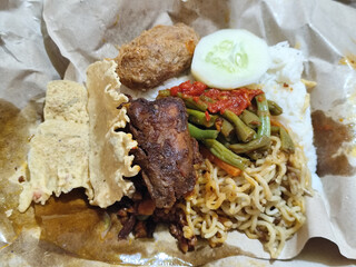 Nasi campur (Nasi Rames) is a typical Javanese Indonesian dish, which consists of white rice served with various side dishes.