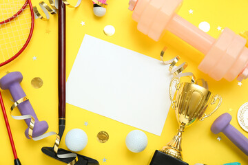 Blank card with gold cup, sports equipment and confetti on yellow background