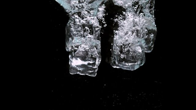 ice cubes in water with bubbles
