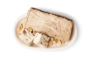 Plate with pieces of tasty marble halva on white background