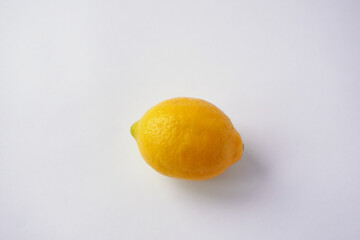 A close-up view of fresh yellow lemon with smooth, glossy textures, showcasing their natural and...