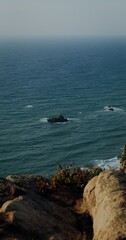 View from the top of the coastal cliff to the sea, the sky merges with the water on the horizon