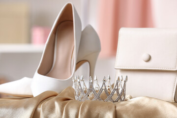 Tiara with bag and heels on prom dress in boutique, closeup