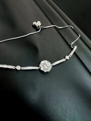 Fototapeta premium Elegant S925 sterling silver necklace displayed on a luxurious black background, highlighting its shine, intricate design, and premium craftsmanship. Captured with a smartphone camera, the photo maint