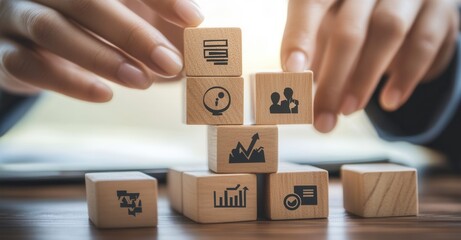 Building success: Hands stacking wooden blocks with icons representing tasks, teamwork, and growth for goals, strategy, and achievement.