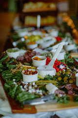 Elegant charcuterie board with cheese, meats, olives, and dips