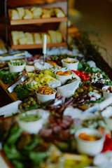 Elegant charcuterie board with cheese, meats, olives, and dips