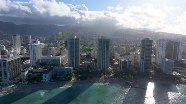 Aerial view of back lit high rise buildings at Waikiki Beach