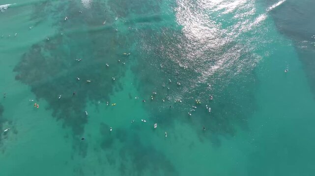 Overhead surfers and small waves at Waikiki Beach