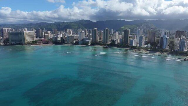 Wide aerial view moving toward Waikiki Beach towers