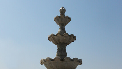 Elegant white marble sculpture with decorated curves