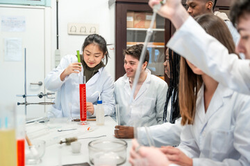 Chemistry students collaborating on experiment in university lab