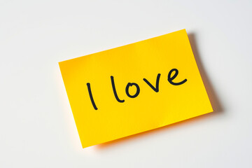 Text I love on yellow note