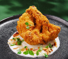 Delicious crispy fried dish served on a black plate