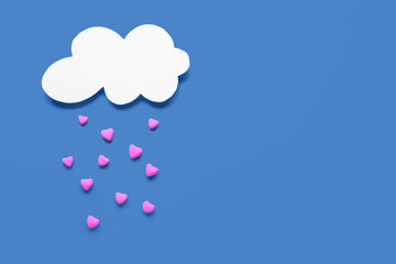 Composition with paper cloud and hearts for Valentine's Day on blue background
