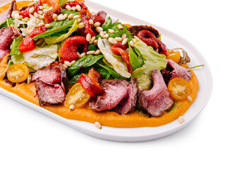 Colorful salad with grilled meat and fresh vegetables served elegantly