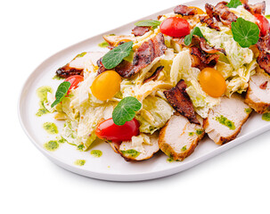 Fresh salad with chicken, bacon, and cherry tomatoes on a plate