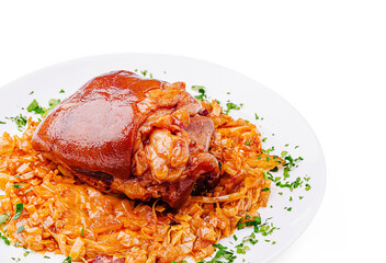 Savory pork knuckle served on a plate with seasoned cabbage