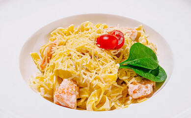 Creamy pasta dish with salmon, cherry tomatoes, and spinach