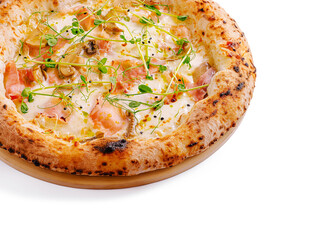 Freshly baked pizza with toppings and herbs on a wooden base