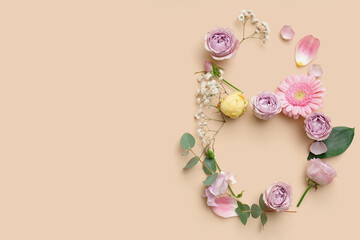 Figure 8 made of different beautiful flowers on yellow background. International Women's Day