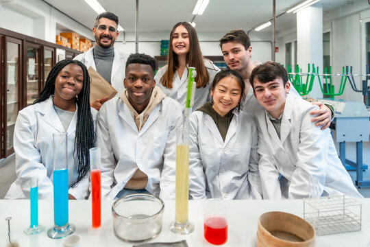University students and teacher posing in chemistry lab
