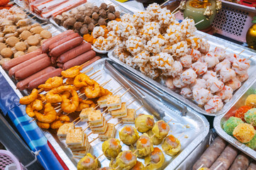 Fast food at the Asian night market in Asia. Traditional Vietnamese street food on the counter in...