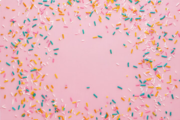 Colorful sprinkles on pink background