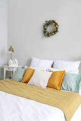Interior of light bedroom with Easter wreath