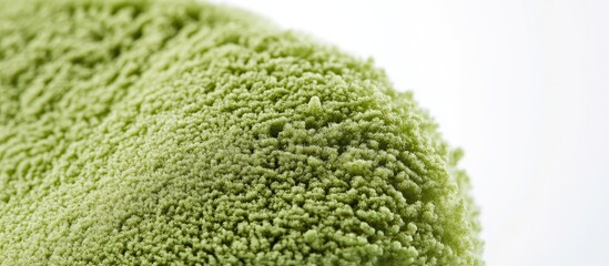 Close-up of a vibrant green powder puff with textured surface and handles, set against a clean white background for design examination.