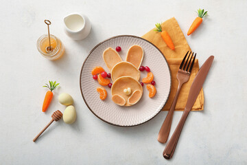 Funny Easter bunny pancakes with painted eggs on white background