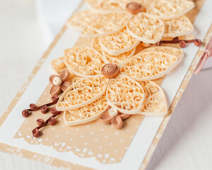 Colored quilling flowers from paper on a white cardboard card. Handmade card. Paper flowers. What to make from colored paper