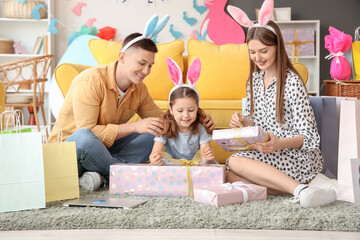 Happy family in bunny ears with gifts at home. Easter Sale